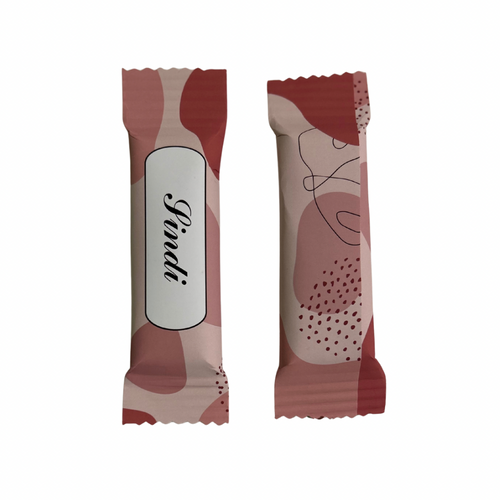 Two individually wrapped chocolate bars one showing front and the other back with a modern abstract camouflage pattern in shades of dusty rose, terracotta and cream. One bar features a white label with the brand name in black script.